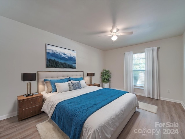 bedroom featuring light hardwood / wood-style flooring and ceiling fan