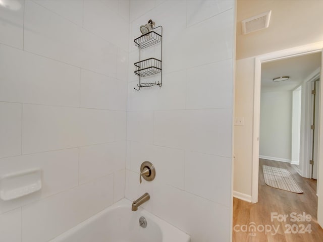 4605 Coronado Dr Unit M, Charlotte, NC 28212 - bathroom with visible vents, baseboards, wood finished floors, and bathing tub / shower combination
