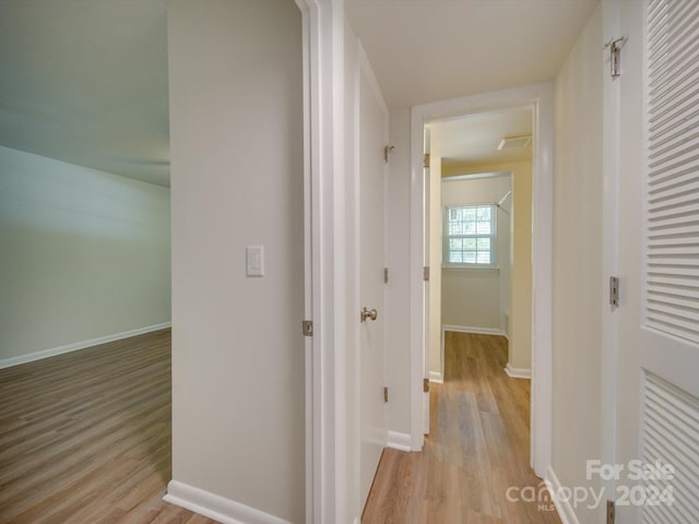 corridor with light wood-type flooring