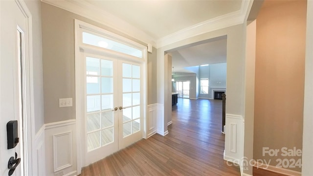 hallway featuring french doors, crown molding, and wood-type flooring