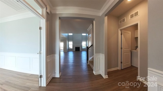 hall with ornamental molding and dark hardwood / wood-style flooring