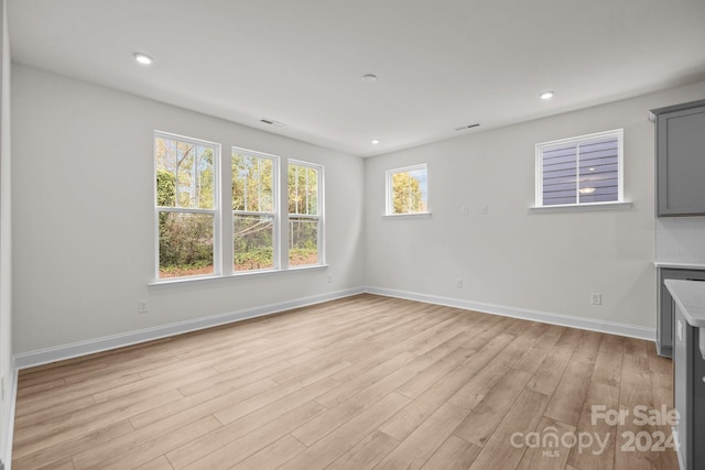 unfurnished living room featuring light wood-type flooring