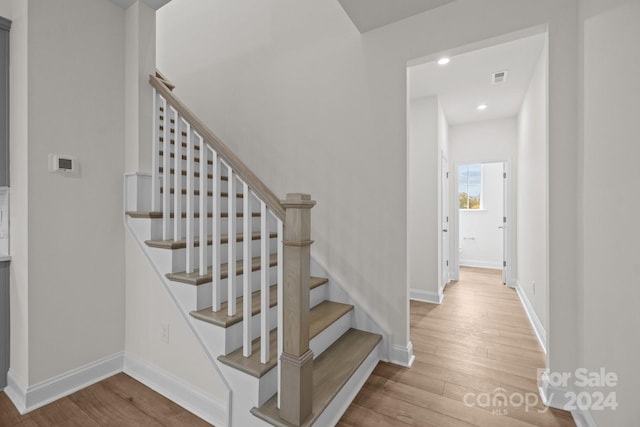 stairs featuring wood-type flooring