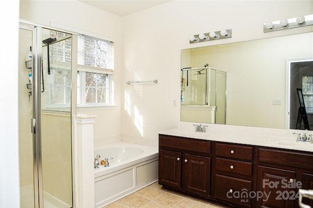 bathroom with tile patterned flooring, shower with separate bathtub, and vanity