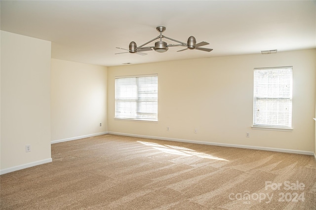 unfurnished room featuring light colored carpet and ceiling fan