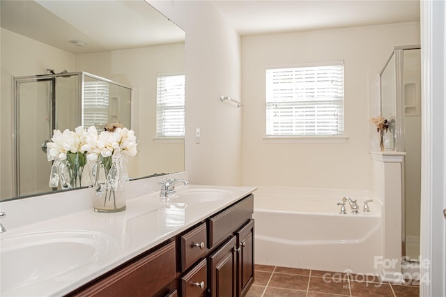 bathroom with vanity, a wealth of natural light, tile patterned floors, and separate shower and tub