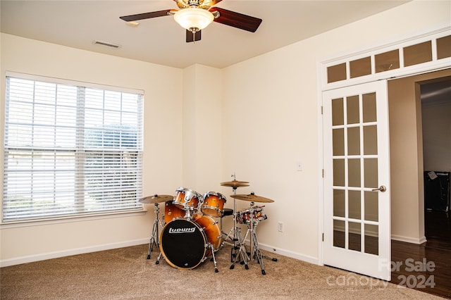 interior space featuring carpet flooring and ceiling fan