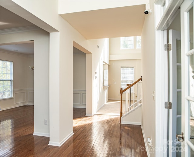 foyer featuring dark hardwood / wood-style flooring and crown molding