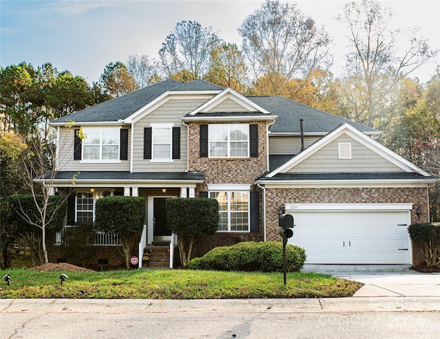 view of front of property featuring a garage and covered porch