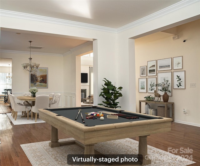 rec room with ornamental molding, billiards, dark hardwood / wood-style flooring, and an inviting chandelier