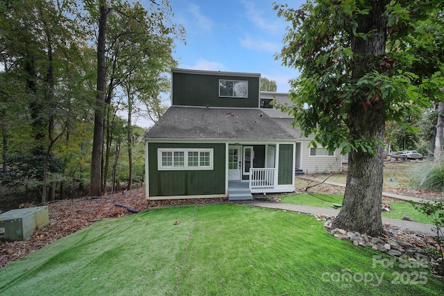 back of house featuring a sunroom and a lawn