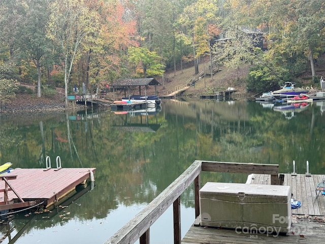 view of dock featuring a water view and a view of trees