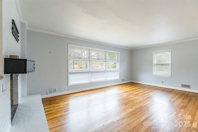 unfurnished living room with crown molding and light hardwood / wood-style flooring