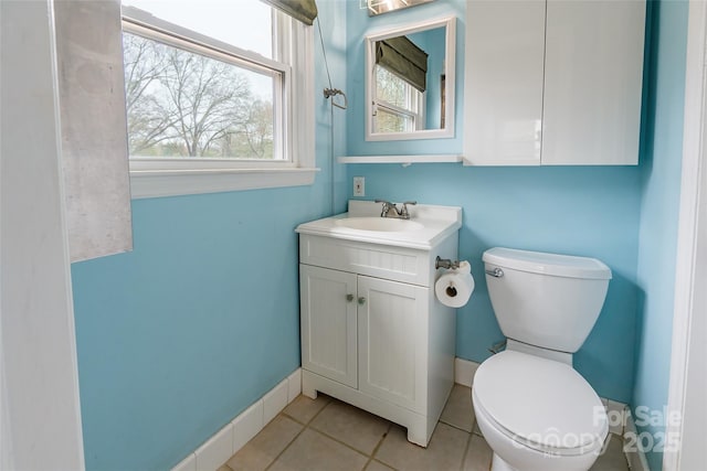 bathroom featuring vanity, tile patterned flooring, and toilet