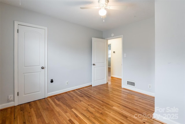 empty room featuring ceiling fan and light wood-type flooring