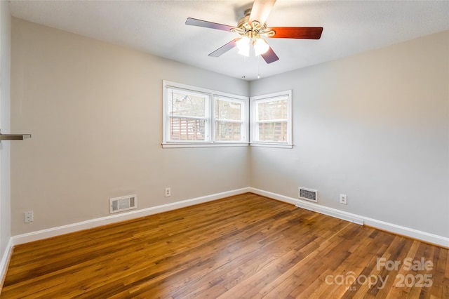 spare room featuring wood-type flooring and ceiling fan