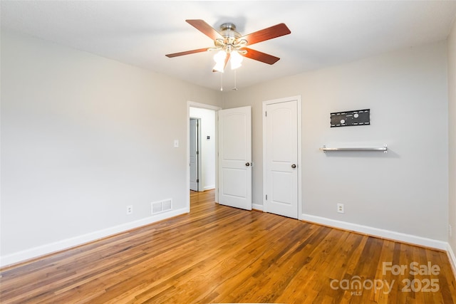 unfurnished bedroom featuring hardwood / wood-style flooring and ceiling fan