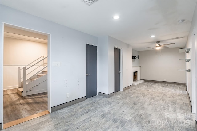 unfurnished room with ceiling fan and light hardwood / wood-style flooring