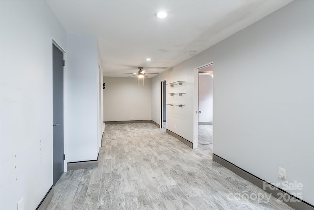 empty room featuring ceiling fan and light hardwood / wood-style floors