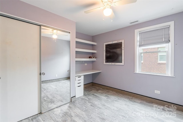 interior space featuring light wood-type flooring and ceiling fan