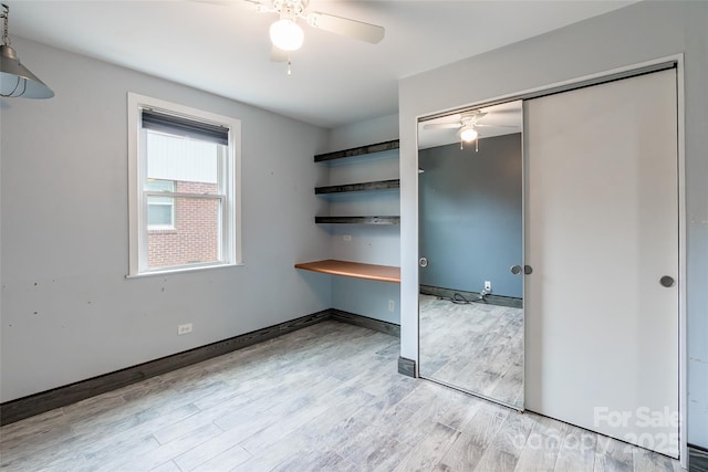 unfurnished bedroom with a closet and light hardwood / wood-style flooring