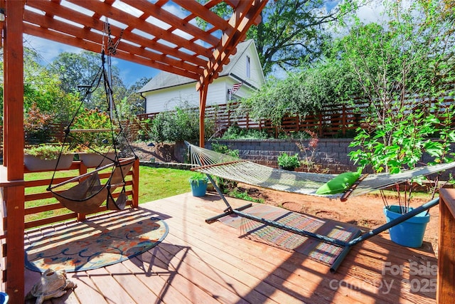 deck featuring a yard and a pergola