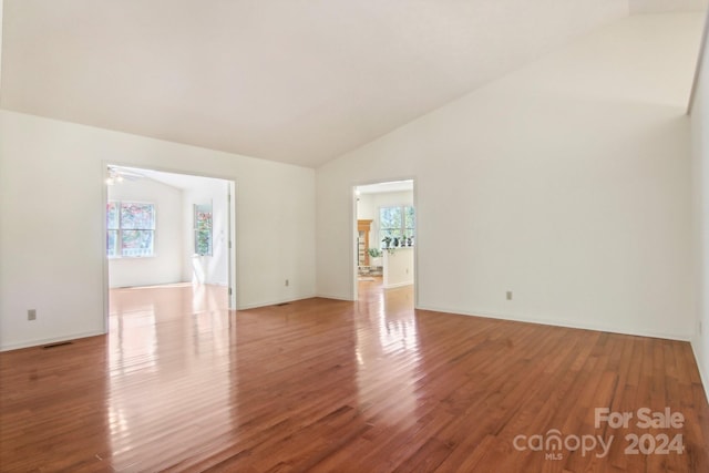 spare room with lofted ceiling, hardwood / wood-style floors, and ceiling fan