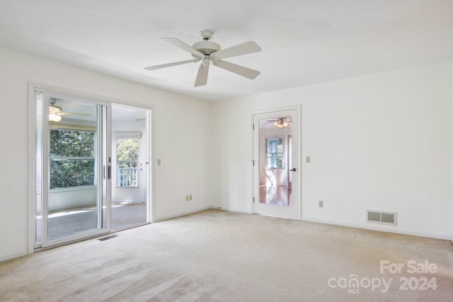 empty room with light colored carpet and ceiling fan