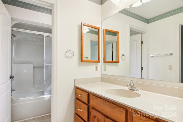 bathroom featuring vanity, shower / bath combination with glass door, and tile patterned flooring