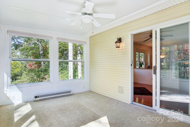 unfurnished sunroom featuring baseboard heating and ceiling fan