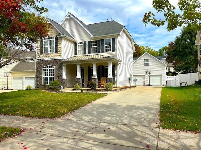 craftsman inspired home featuring a porch, a garage, and a front lawn