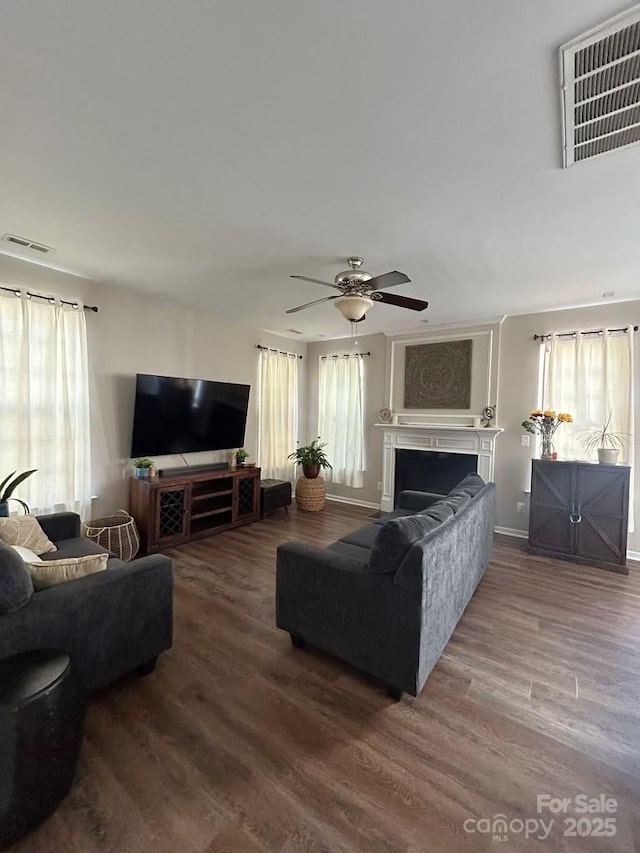 living room featuring ceiling fan and hardwood / wood-style flooring