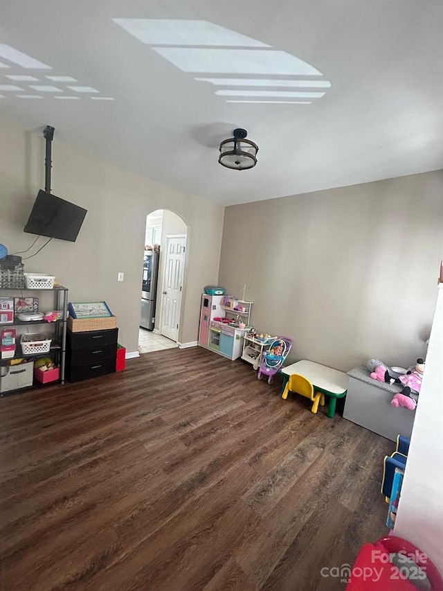 playroom with dark wood-type flooring