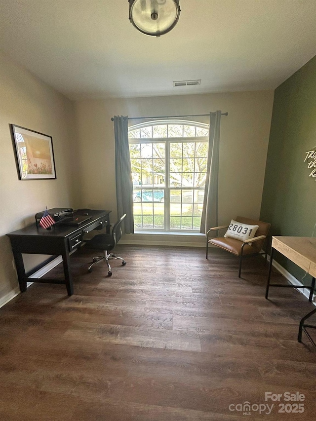 home office with dark hardwood / wood-style floors