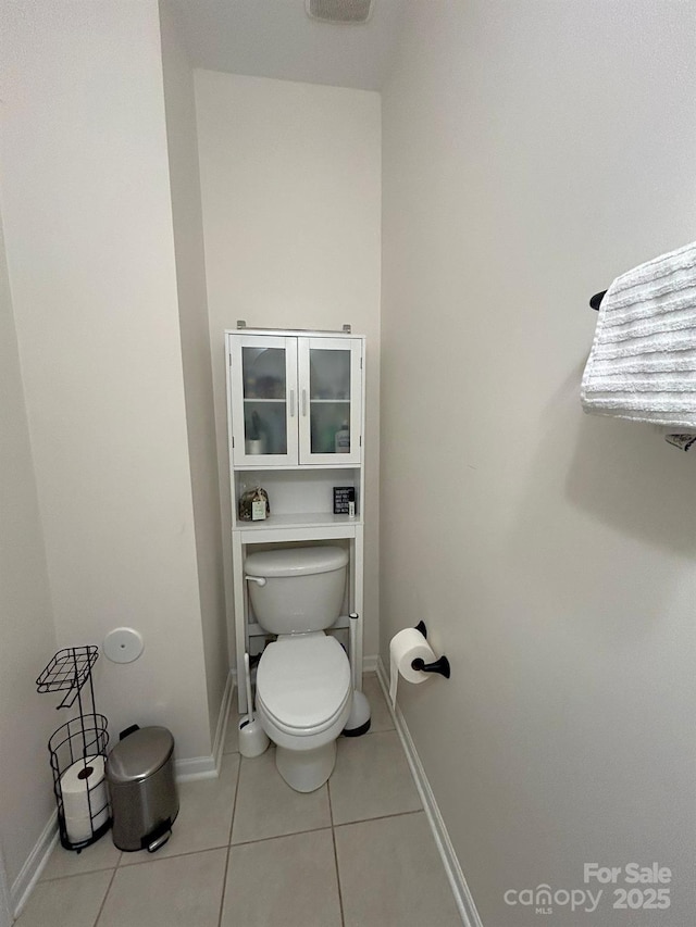 bathroom with tile patterned flooring and toilet