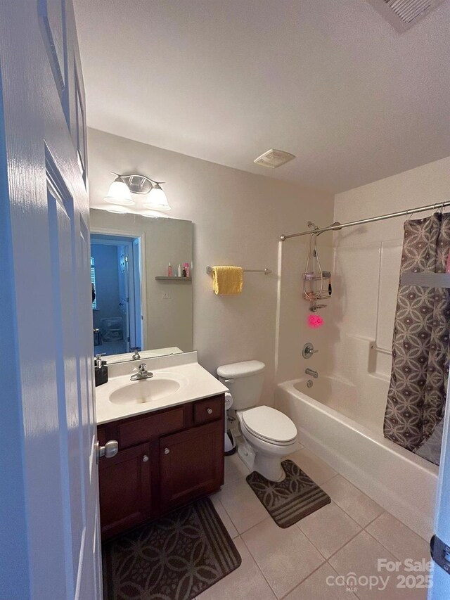 full bathroom with tile patterned floors, vanity, shower / bath combo, and toilet