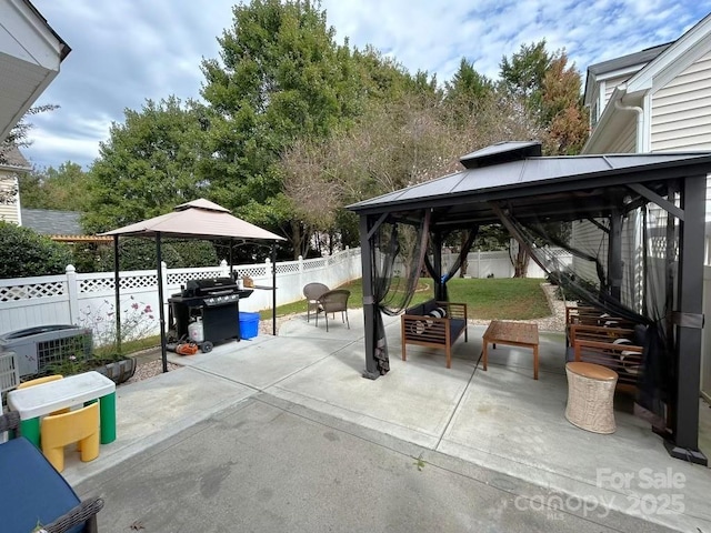 view of patio / terrace featuring a gazebo, area for grilling, and an outdoor hangout area