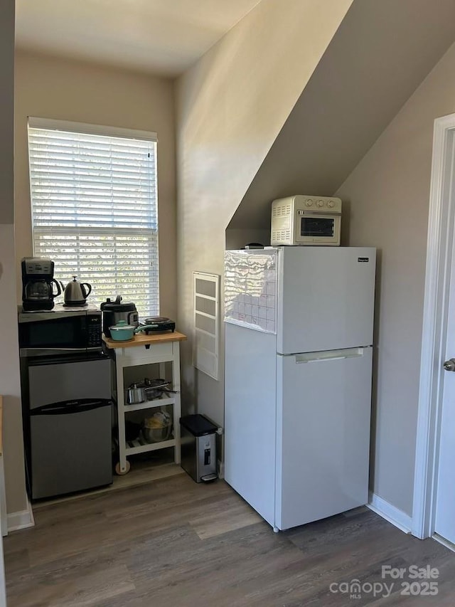 kitchen featuring hardwood / wood-style floors and white appliances