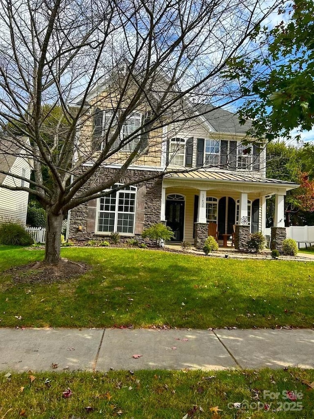 view of front facade with covered porch and a front yard