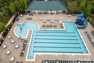 view of pool with a water slide and a patio