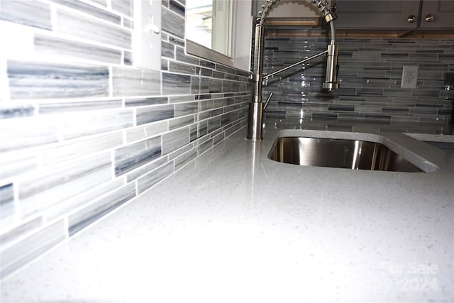 interior details with a sink and tasteful backsplash