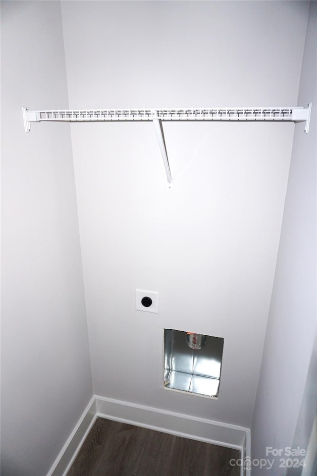 laundry room featuring hookup for an electric dryer, dark wood finished floors, baseboards, and laundry area