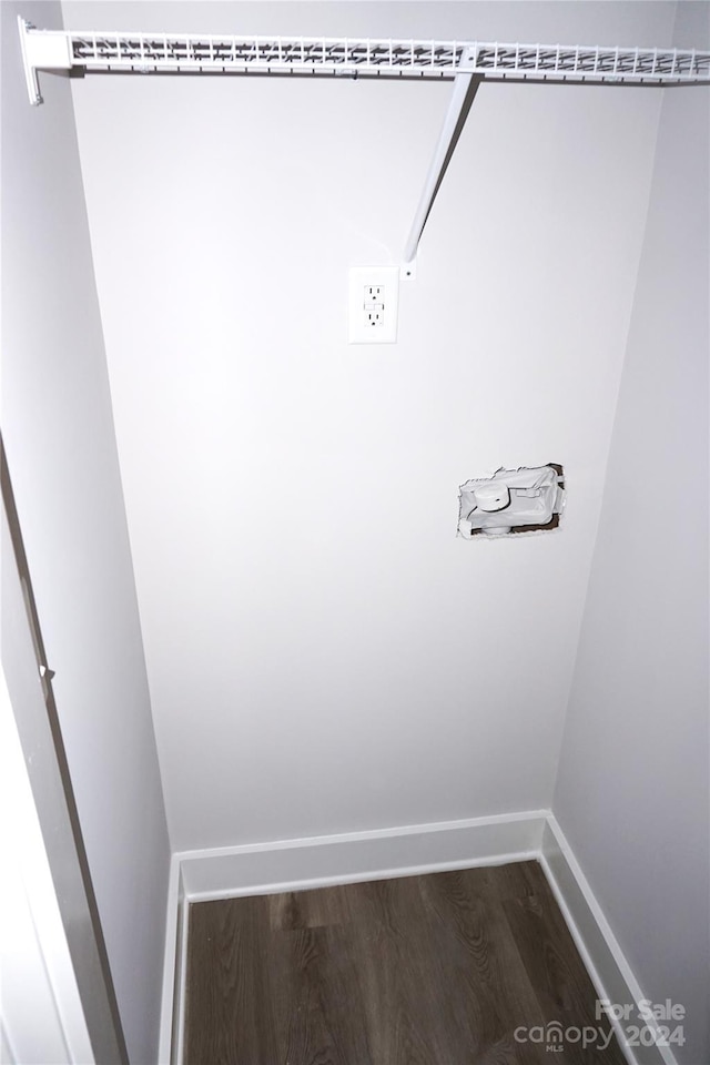 interior space featuring baseboards and dark wood-type flooring