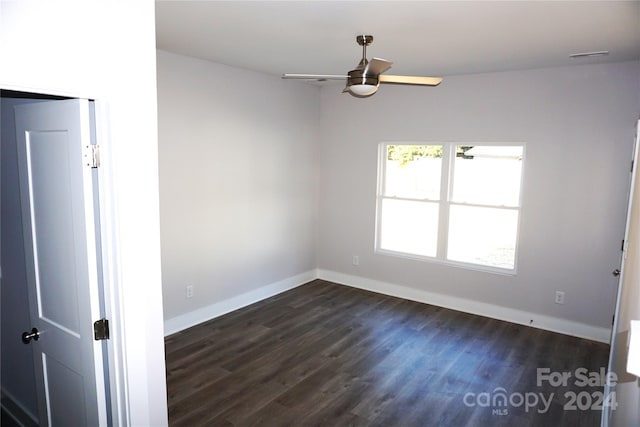 spare room with ceiling fan and dark hardwood / wood-style flooring