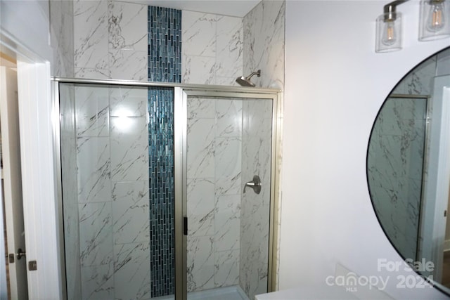 bathroom with a shower with shower door