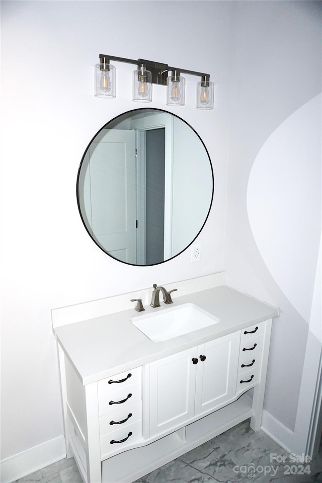 bathroom featuring baseboards, marble finish floor, and vanity