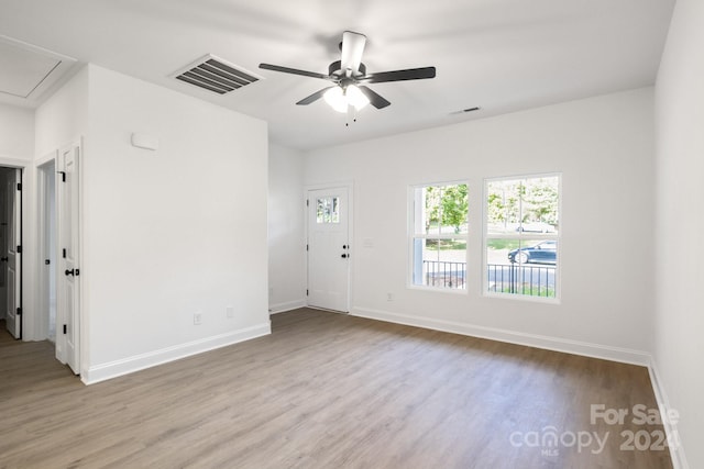 unfurnished room featuring light hardwood / wood-style flooring, ceiling fan, and plenty of natural light