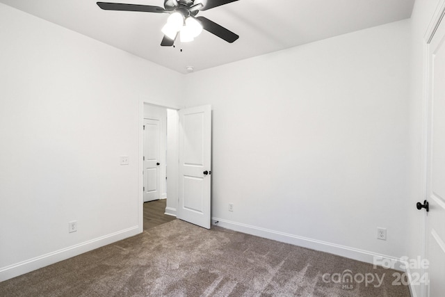 empty room with carpet floors and ceiling fan