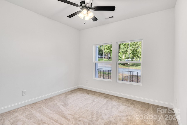 carpeted empty room featuring ceiling fan