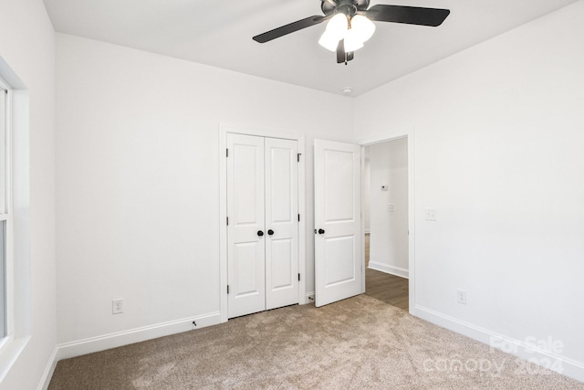 unfurnished bedroom with a closet, ceiling fan, and light carpet